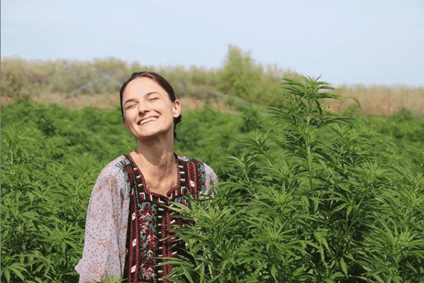 woman and cannabis plant