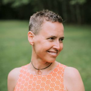 headshot of woman in orange