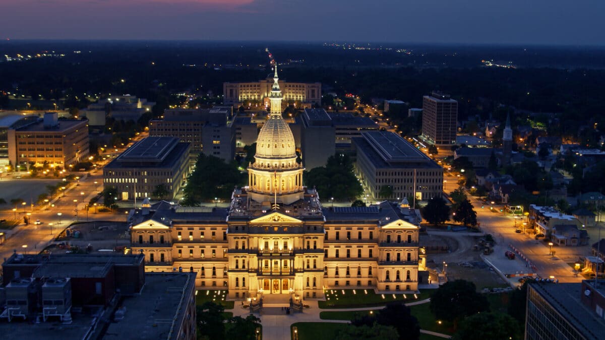 Michigan dispensary storefront with cannabis tax protest signs, reflecting reactions to the new 24% marijuana wholesale tax in Michigan.