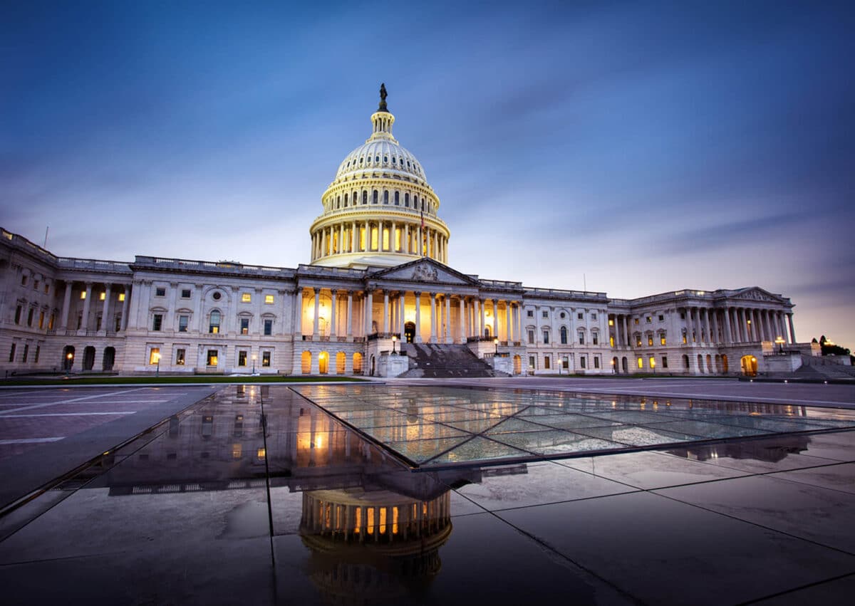 The Capitol building in Washington DC illuminated against a stormy sky, symbolizing federal marijuana legalization efforts through the MORE Act.
